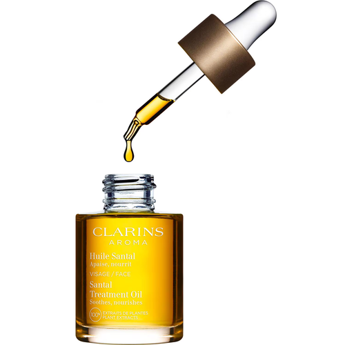 Flacon ouvert Clarins Huile Santal 30 ml avec une goutte d’huile au bout de la pipette.