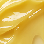 Gros plan de la texture onctueuse jaune doré du baume nettoyant ELEMIS Pro-Collagen Rose.